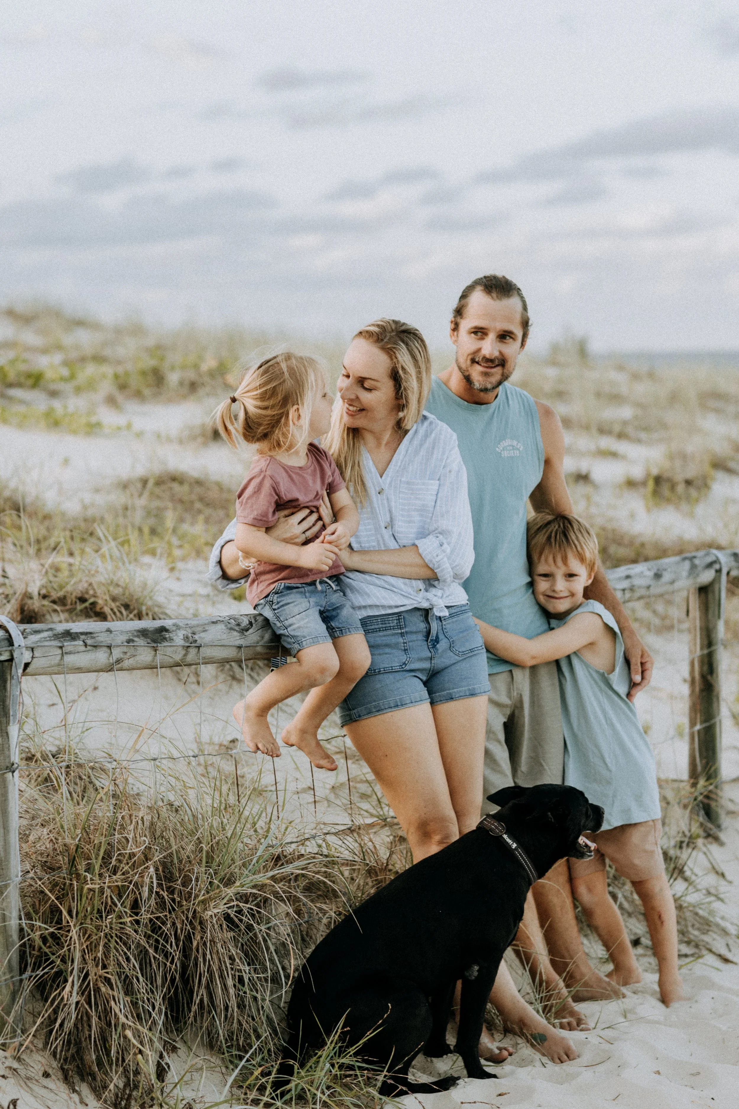 family at the beach with dog