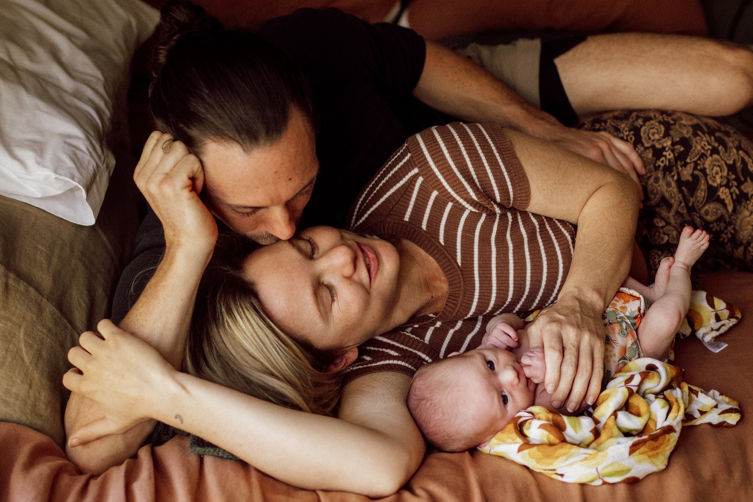 newborn photos at home baby family cuddles