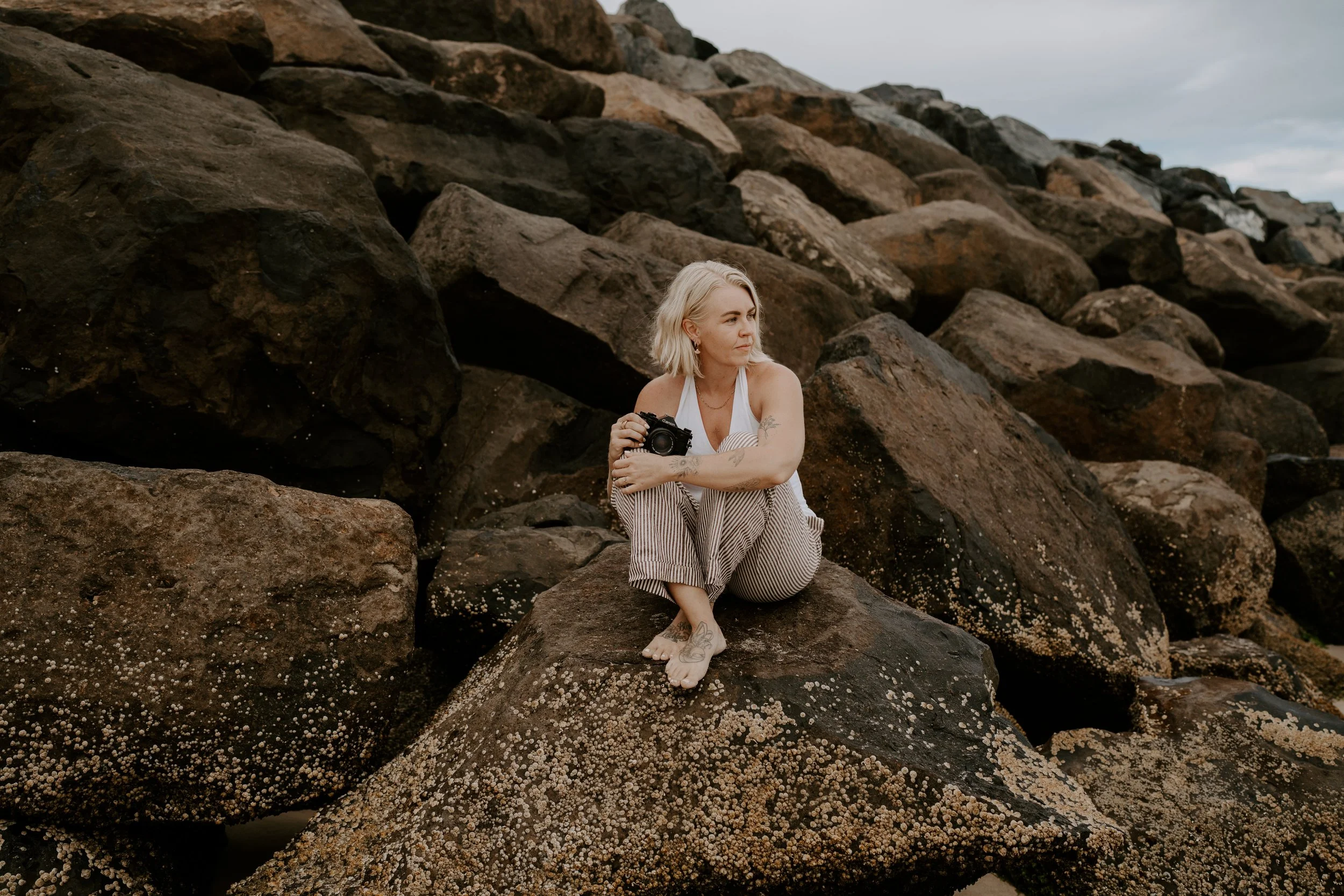photographer on rock with camera