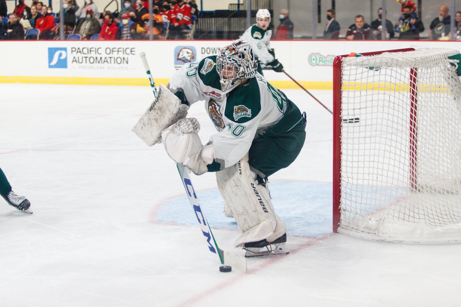 Braden Holt prepares to play the puck in net for the Everett Silvertips