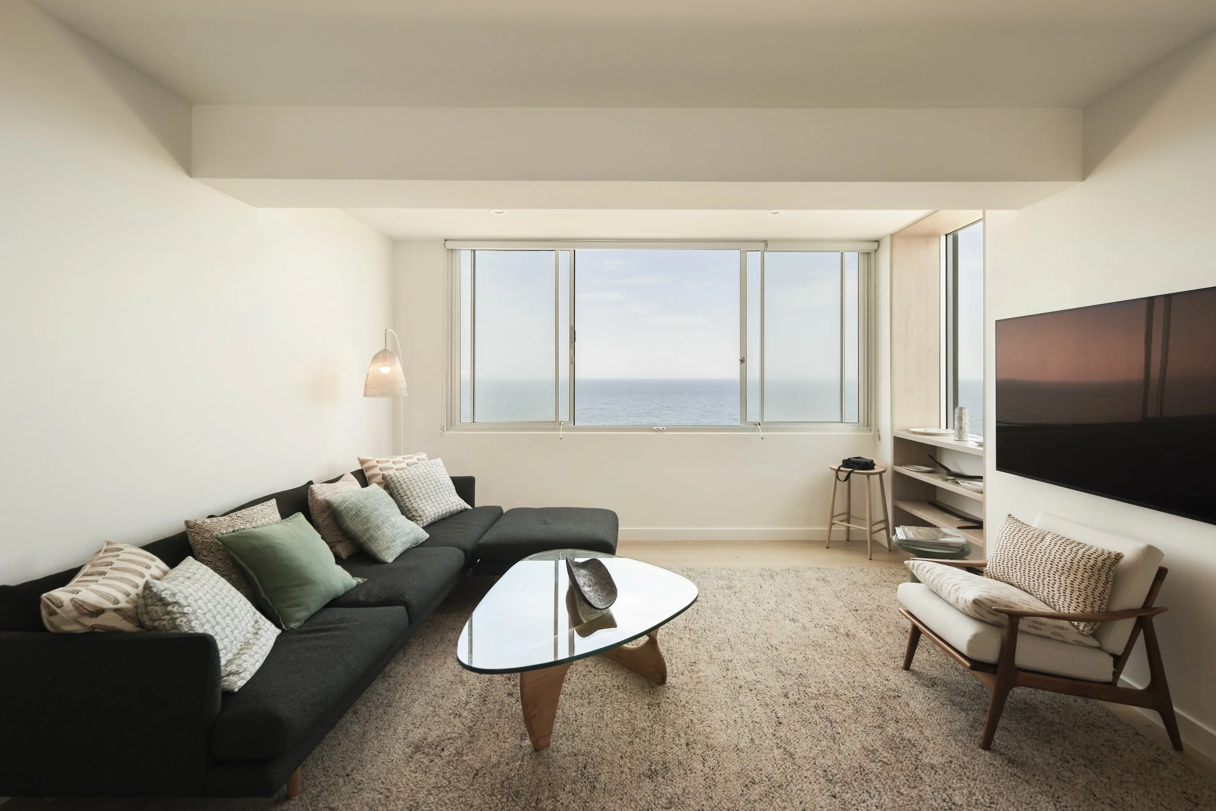 Apartment iving room with ocean views, custom joinery and contemporary furniture