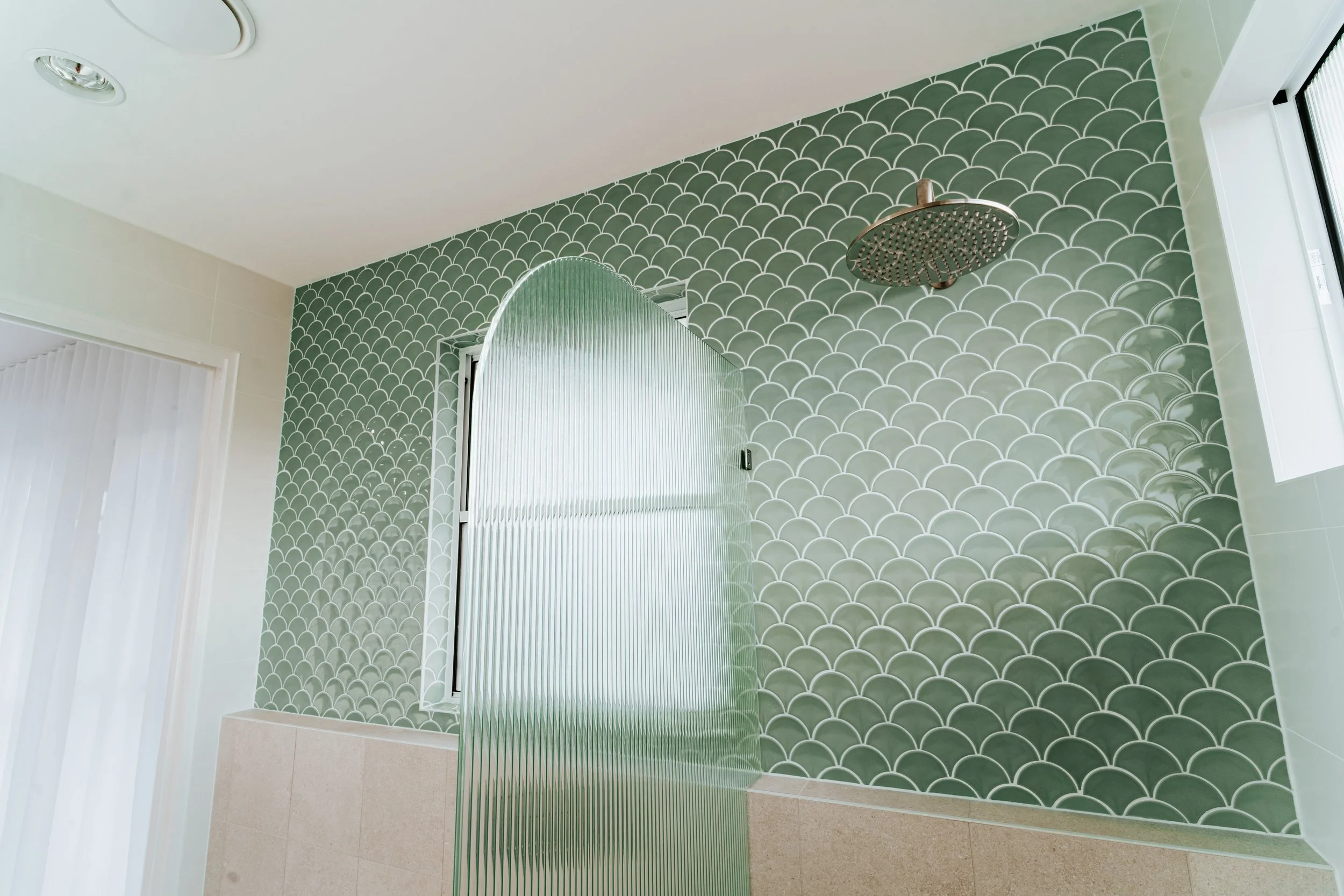 Textured feature wall with green tiles in contemporary Cronulla bathroom design