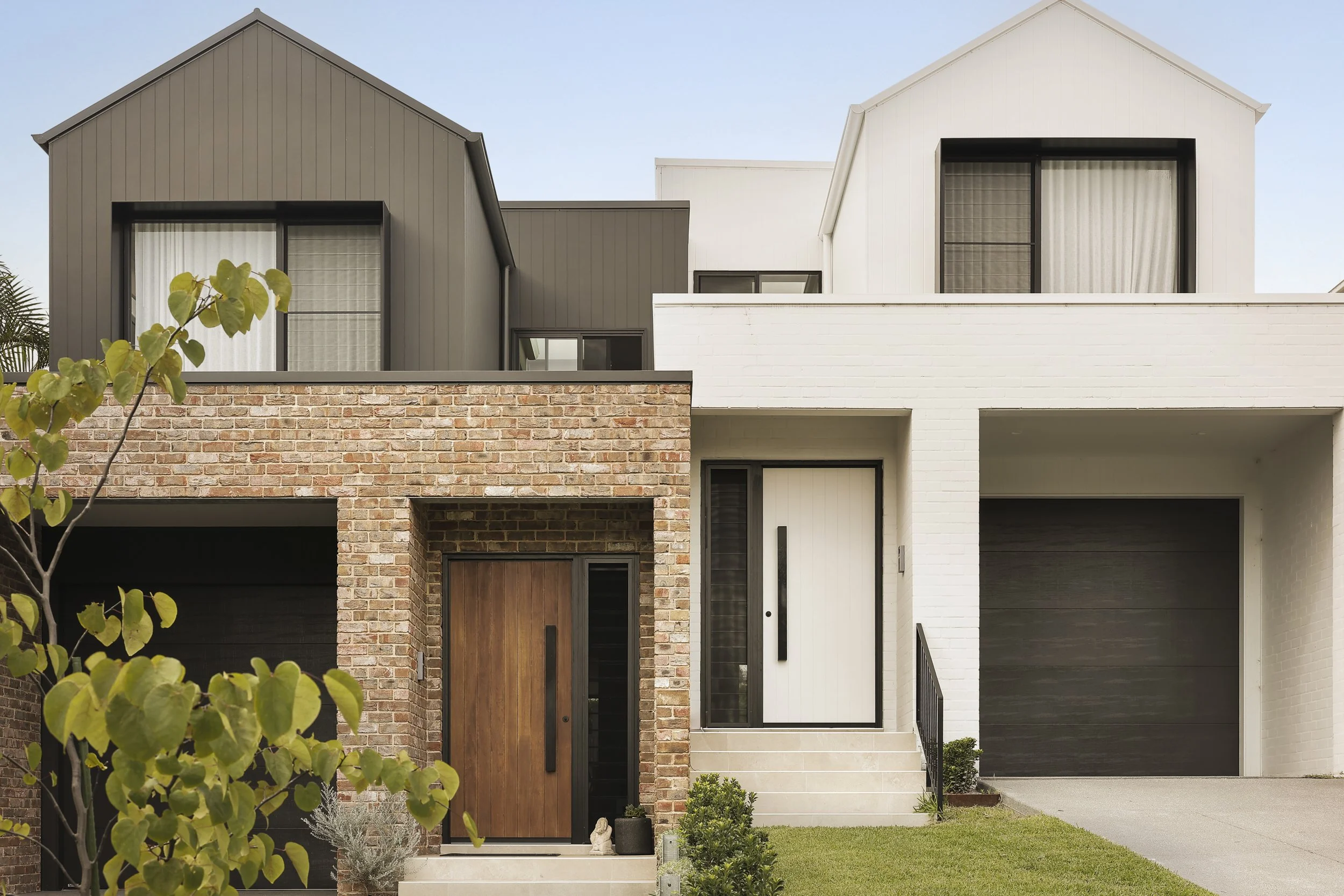 Contemporary duplex facade at 10 Cook Street Caringbah South by Ambient Constructions with contrasting brick and white rendered forms