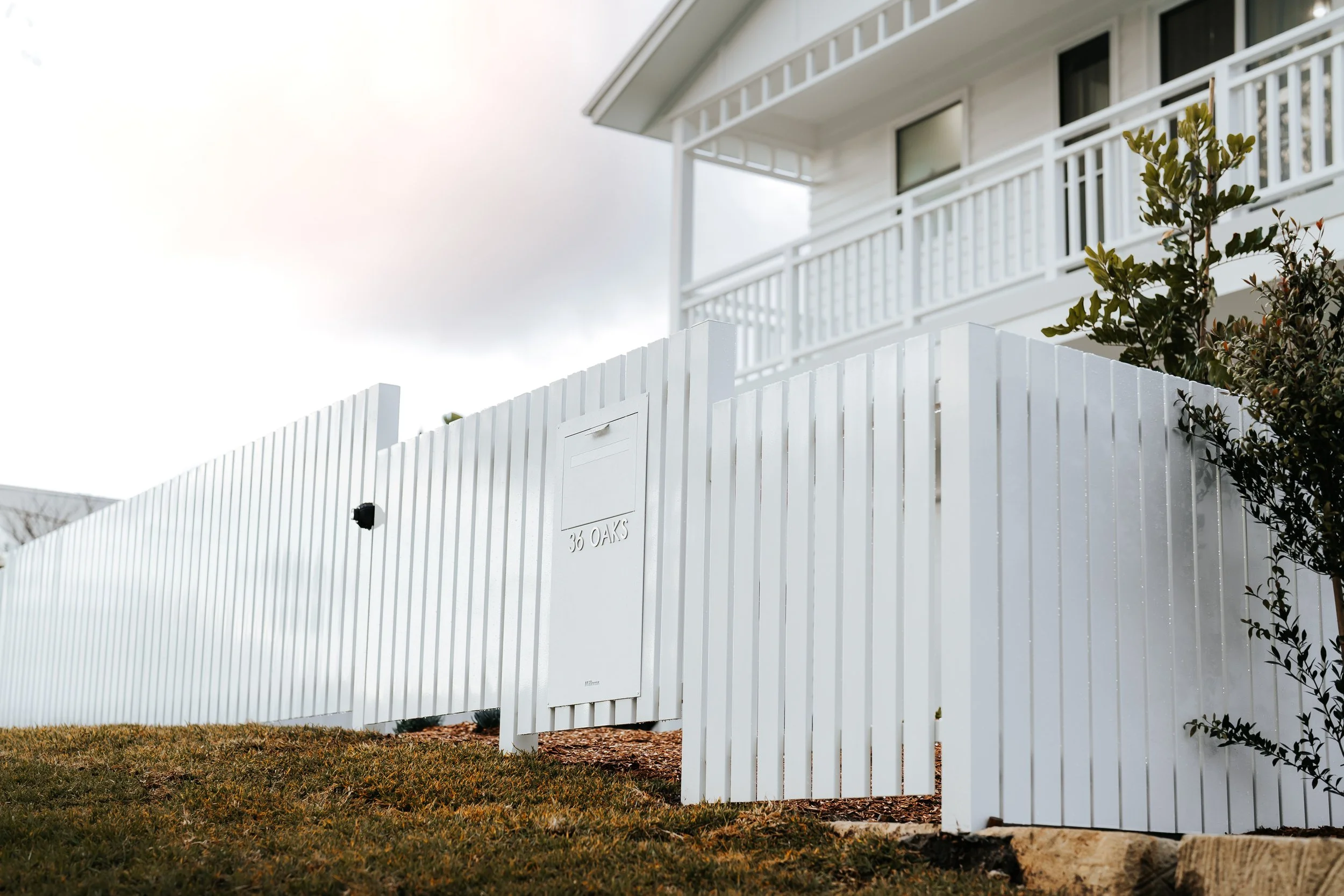 Detailed white timber fence and cladding at Cronulla Hamptons-style duplex