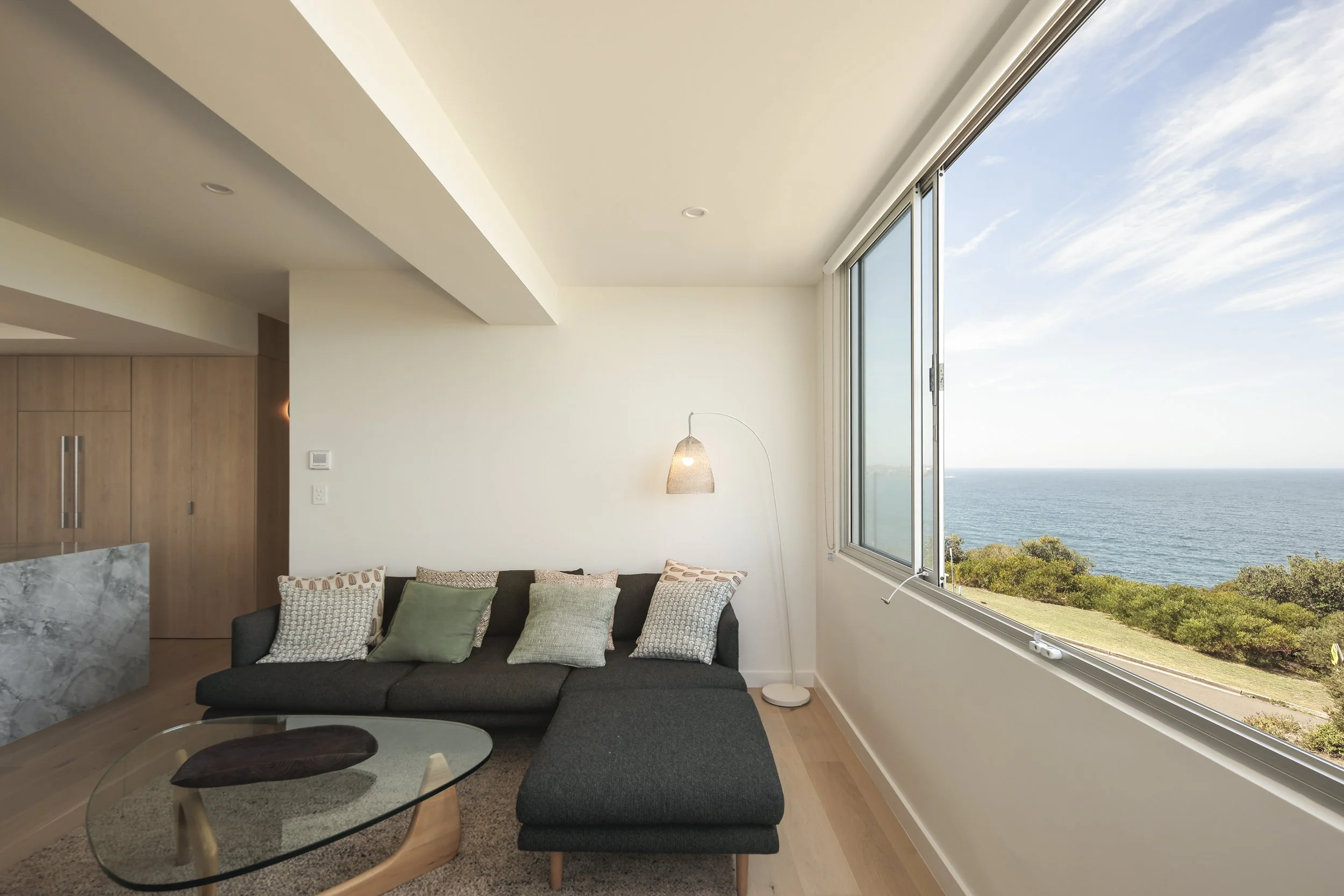 Living space with large windows capturing coastal views and natural light