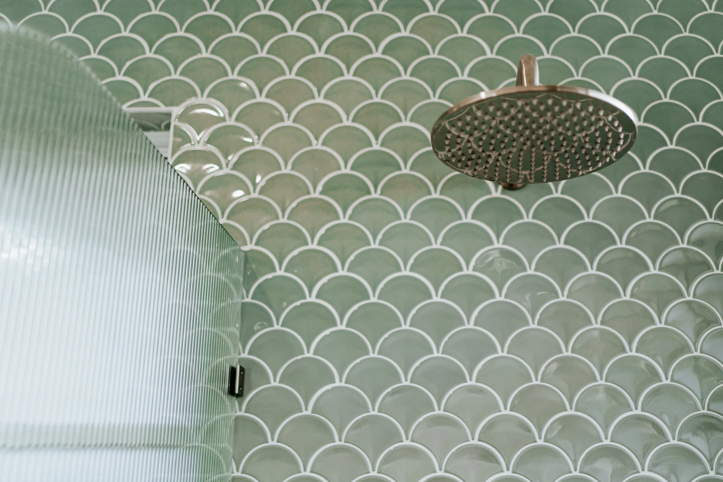 Green fish-scale bathroom tiles with rainfall shower in Hamptons-inspired Cronulla duplex