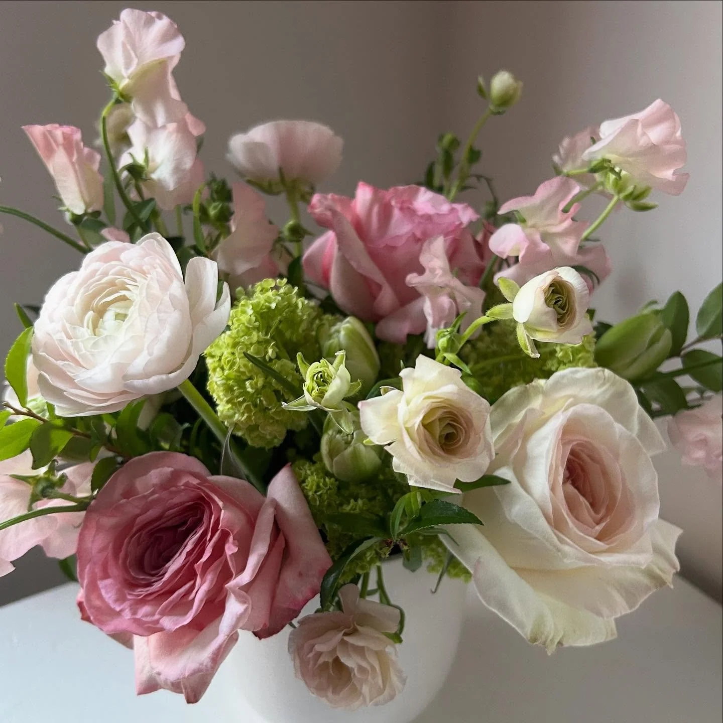 Pretending it’s spring with fragrant white and pink ‘O’Hara’ Roses, Viburnum, double ‘Avant Garde’ Tulips, Butterfly Ranunculus and Sweet Peas