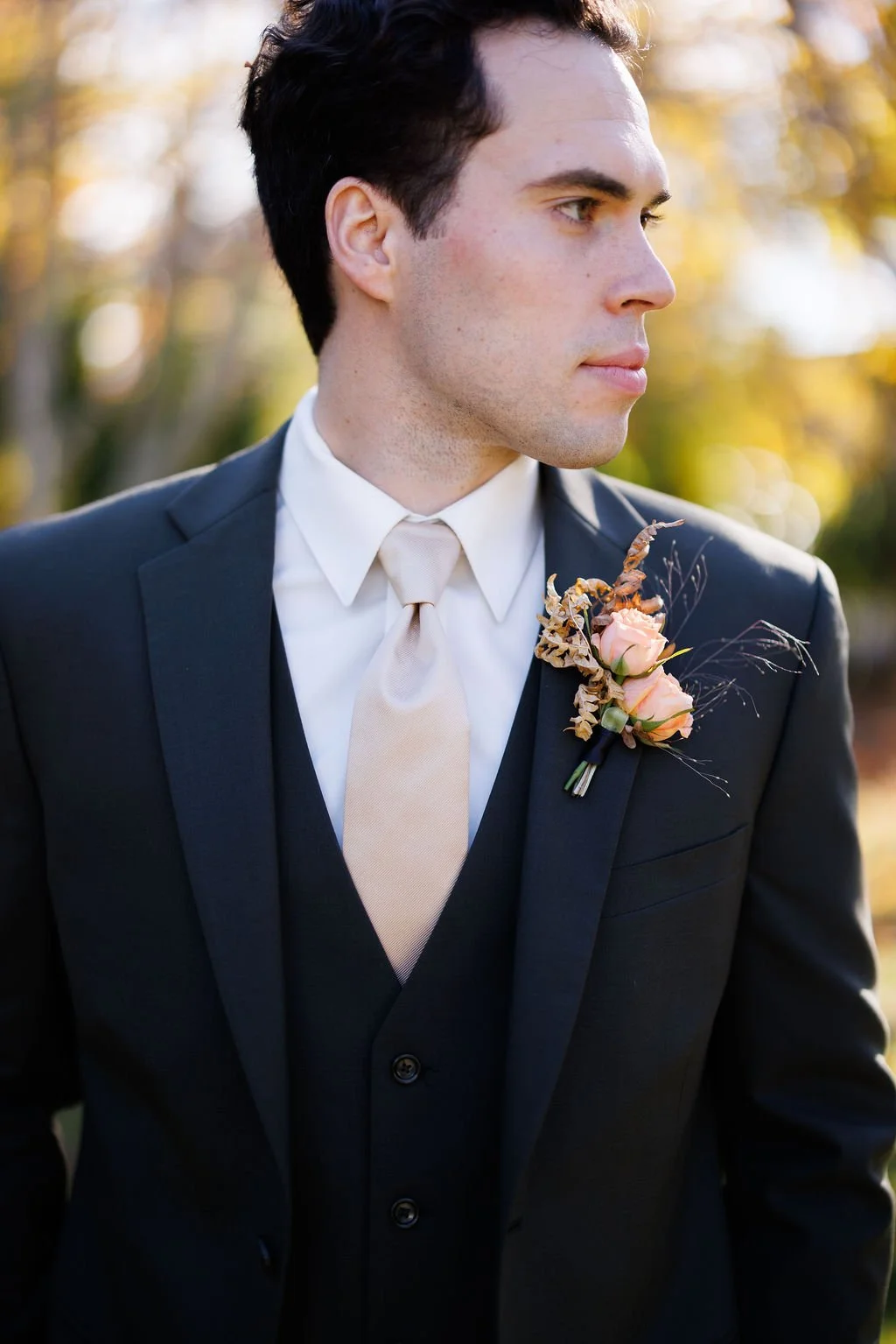  Groom with peach and orange boutonniere by Maine florist.  