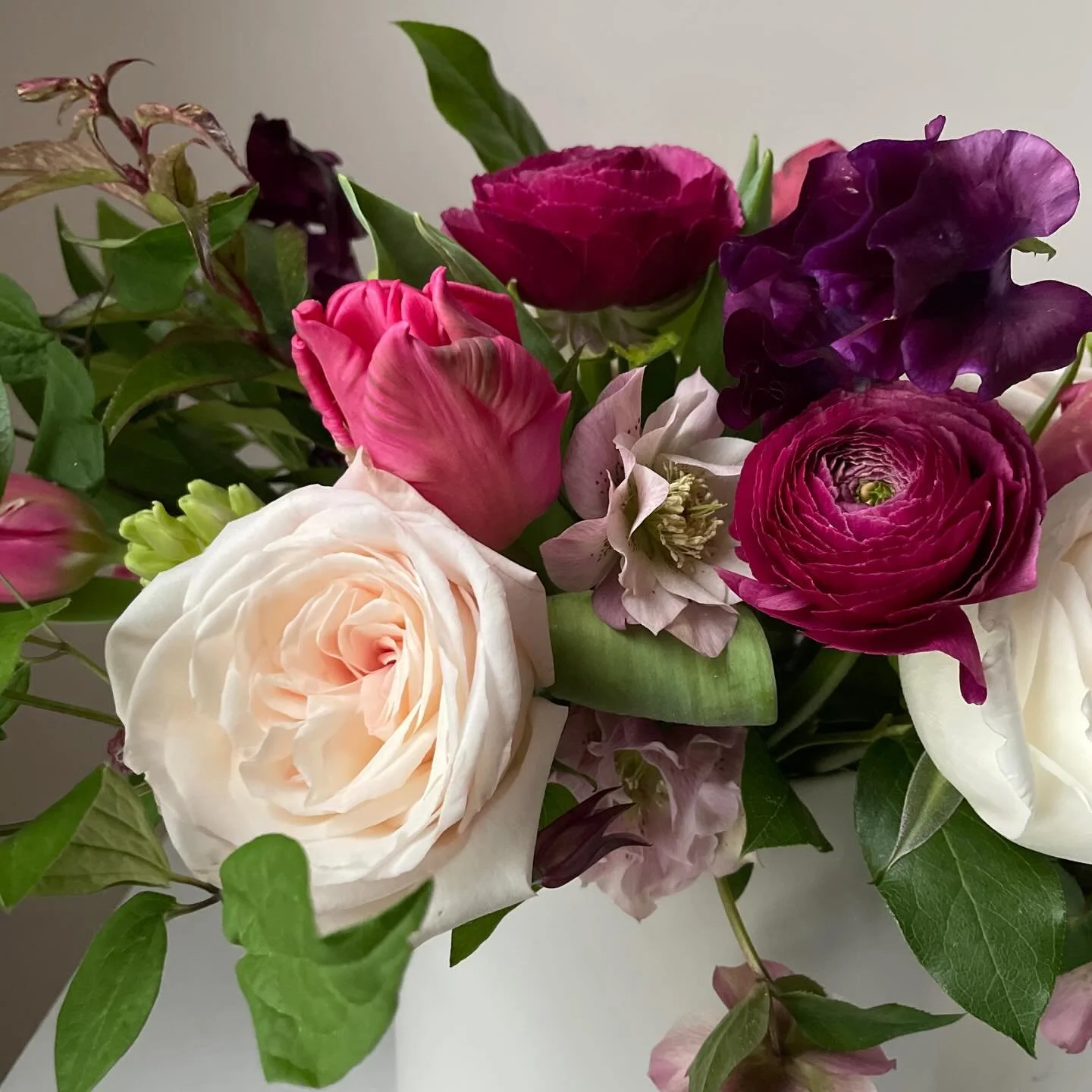 One of my favorite arrangements of white &lsquo;O&rsquo;Hara&rsquo; Roses, double Hellebore, Parrot Tulips, Ranunculus, Hyacinth and Sweet Peas. 💗