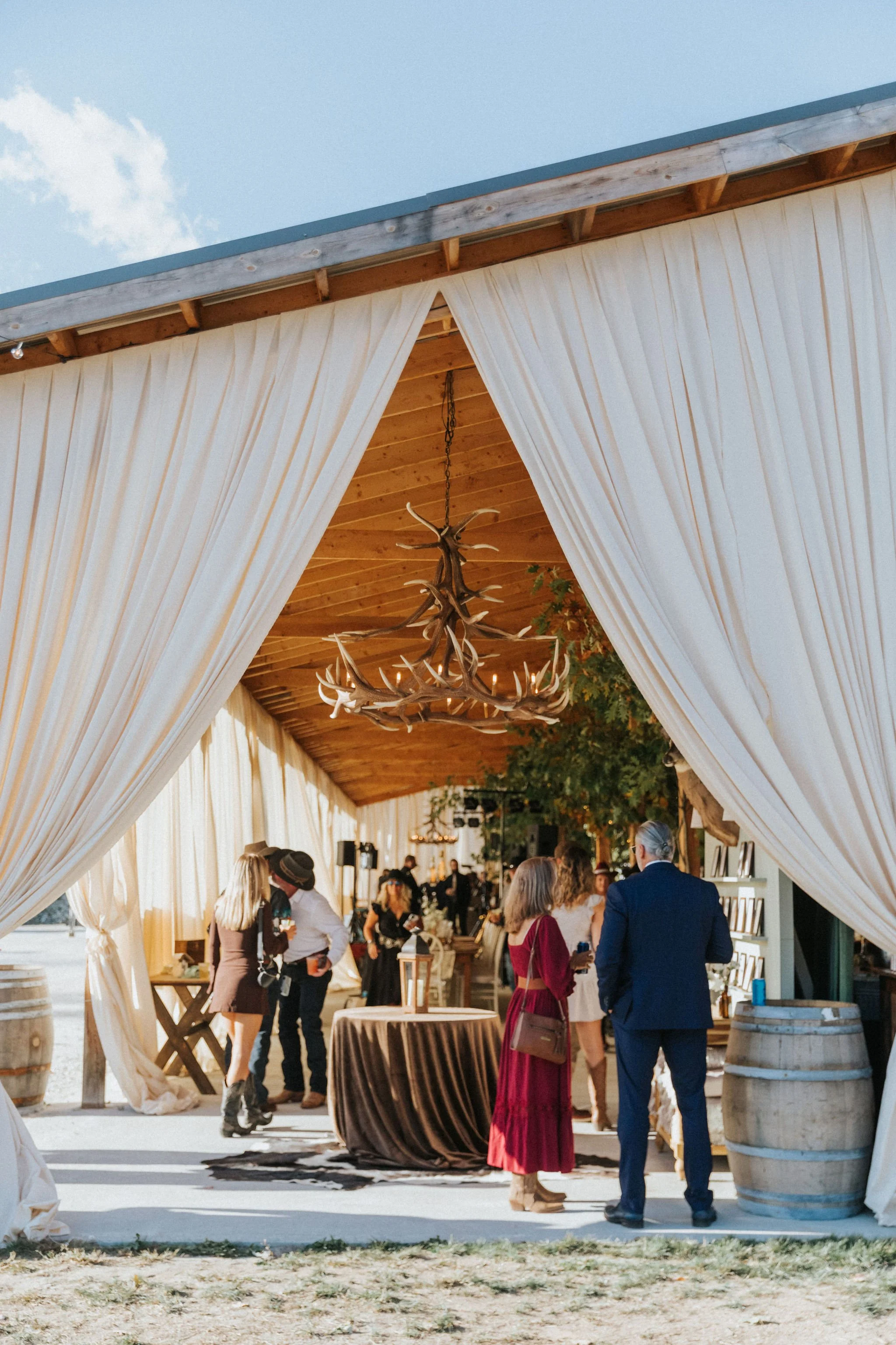 guests-enjoying-drinks-at-rustic-maine-wedding-celadon-floral