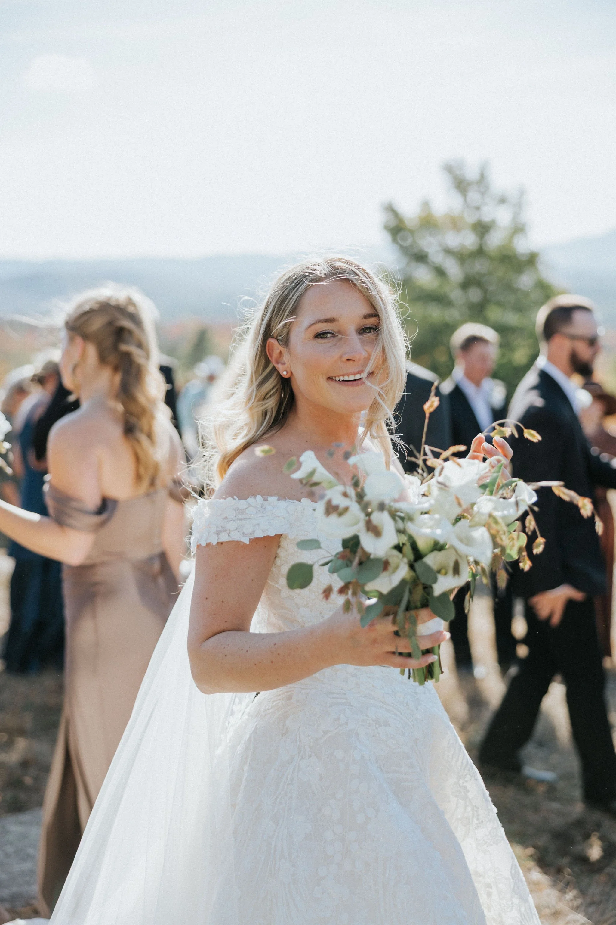 Bride smiling holding Calla Lily wedding bouquet by Maine florist Celadon Floral