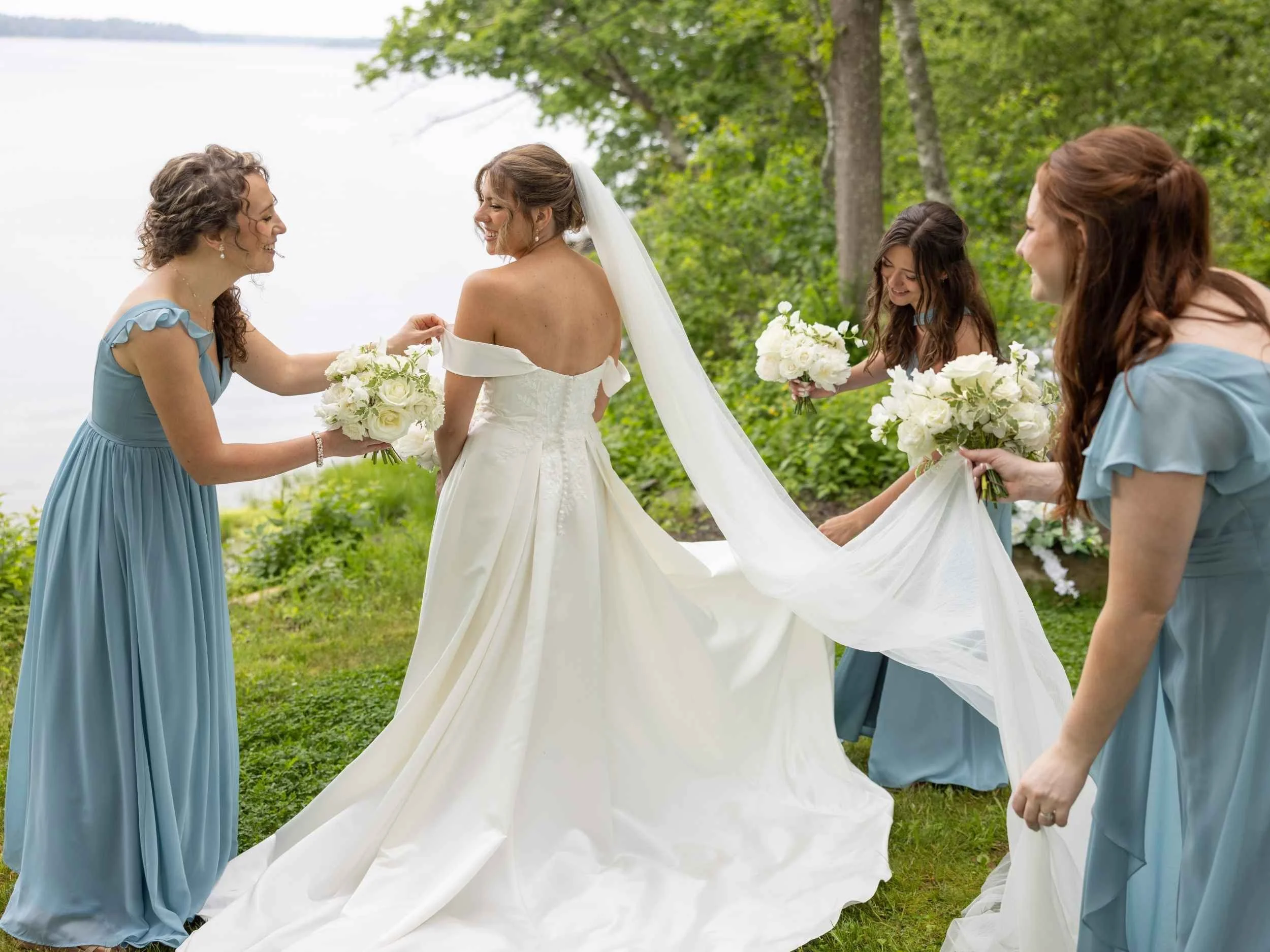 Bride and Bridesmaids holding frilly white bouquets by Harpswell, Maine Florist Celadon Floral