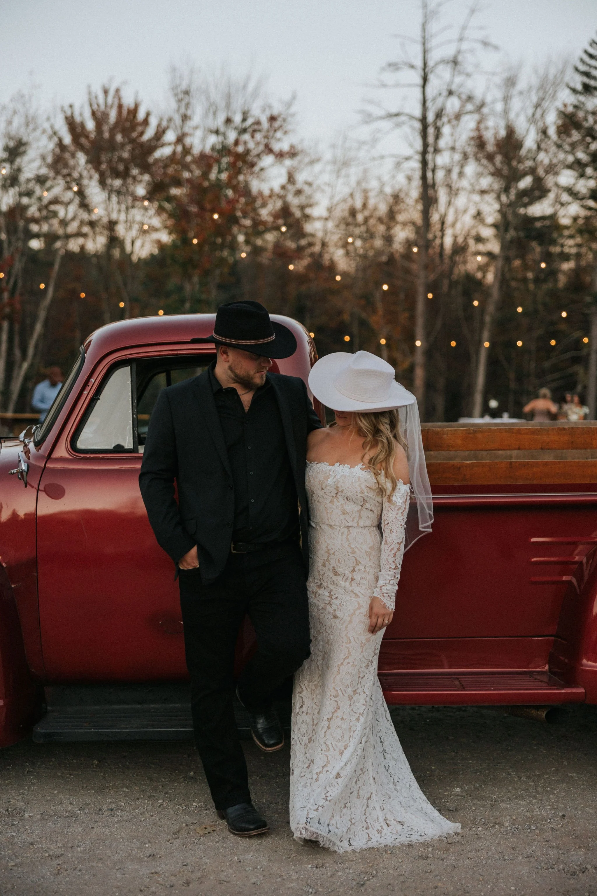 rustic Maine wedding couple portrait by vintage red truck with design by Maine wedding florist Celadon Floral