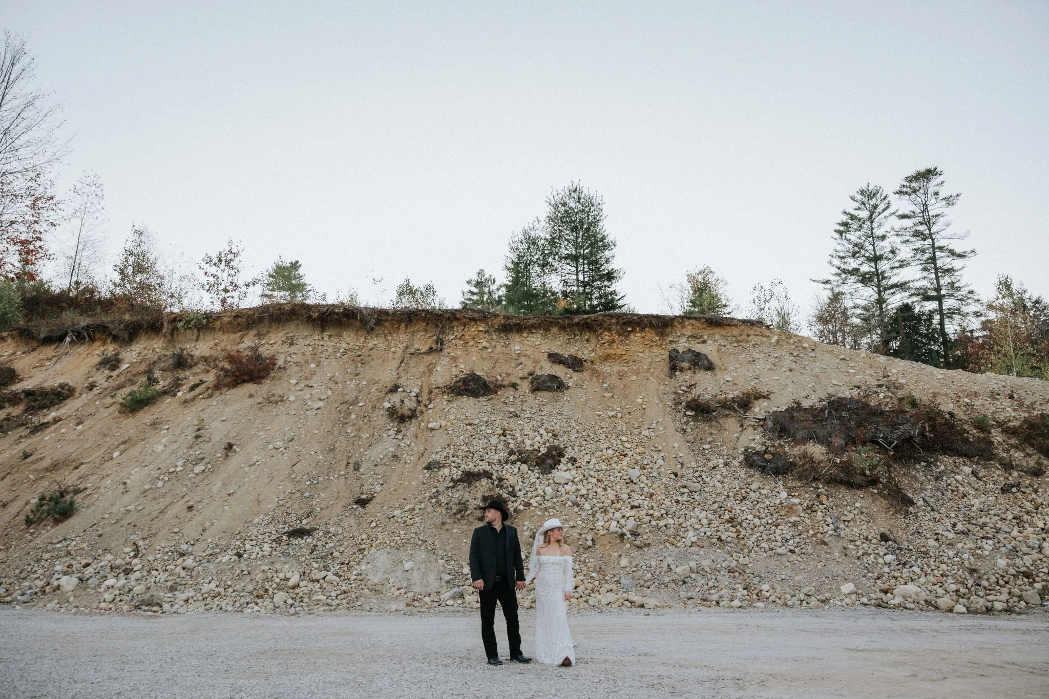 Maine wedding Bride and Groom holding hands in a rustic setting
