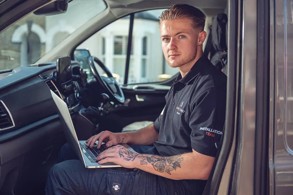 Chimney Installation team member using laptop in van of chimney company ChimneySmart in North London