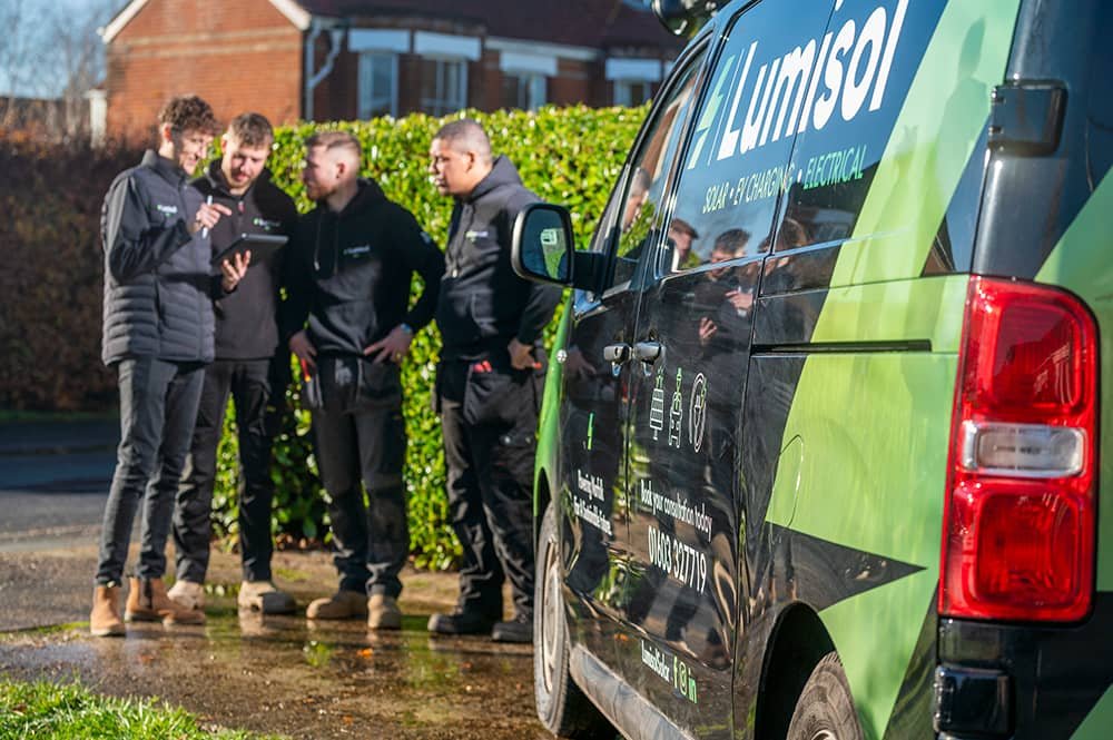 Director of Lumisol electrical company briefing engineers beside a branded company van before starting work in Norfolk