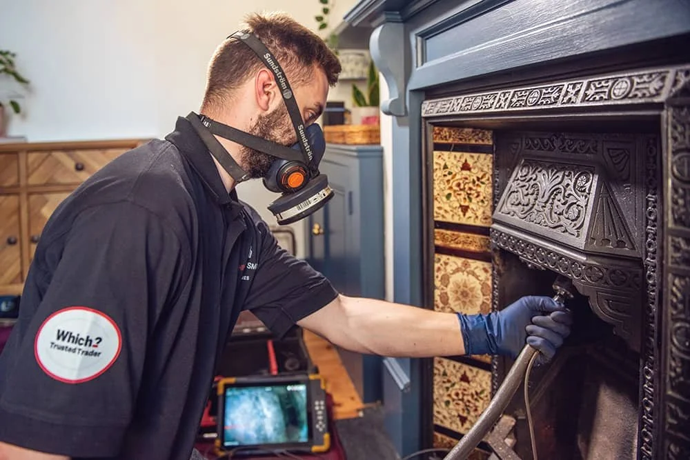 Chimney Installation team member with mask on performing a chimney inspection of company ChimneySmart in North London