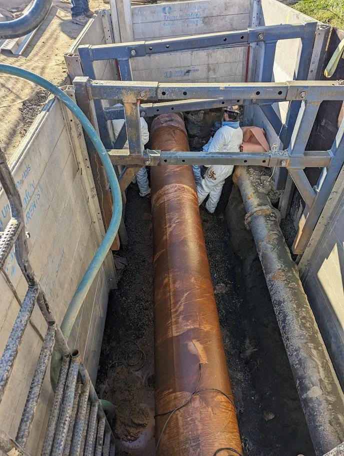 Workers in trench during pipeline remediation