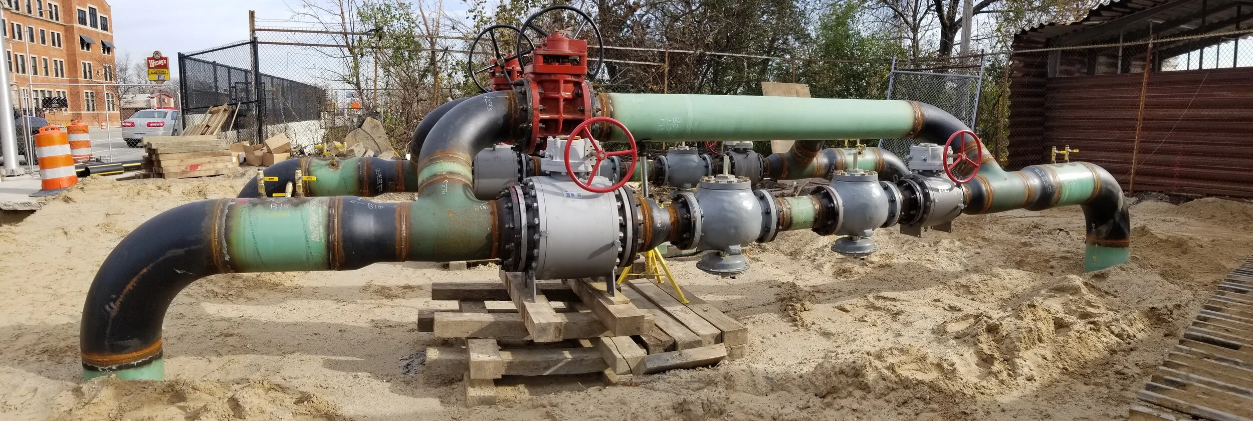 Industrial pipeline fabrication with large valves and green piping installation