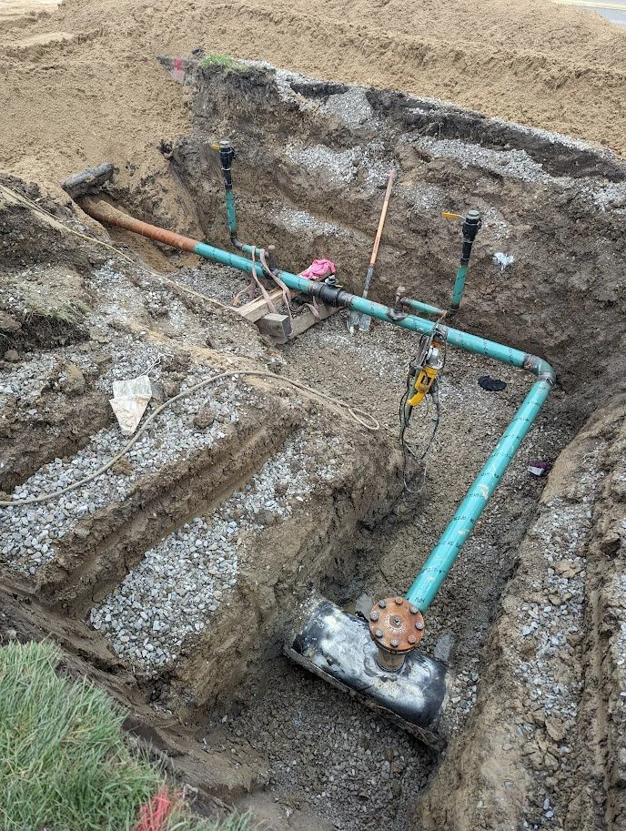 R.L. Coolsaet crew working on natural gas distribution main steel pipes in trench