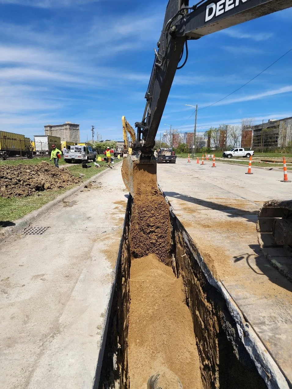 R.L. Coolsaet Construction backfilling an excavation with clean sand to ensure no damage to pipe coating