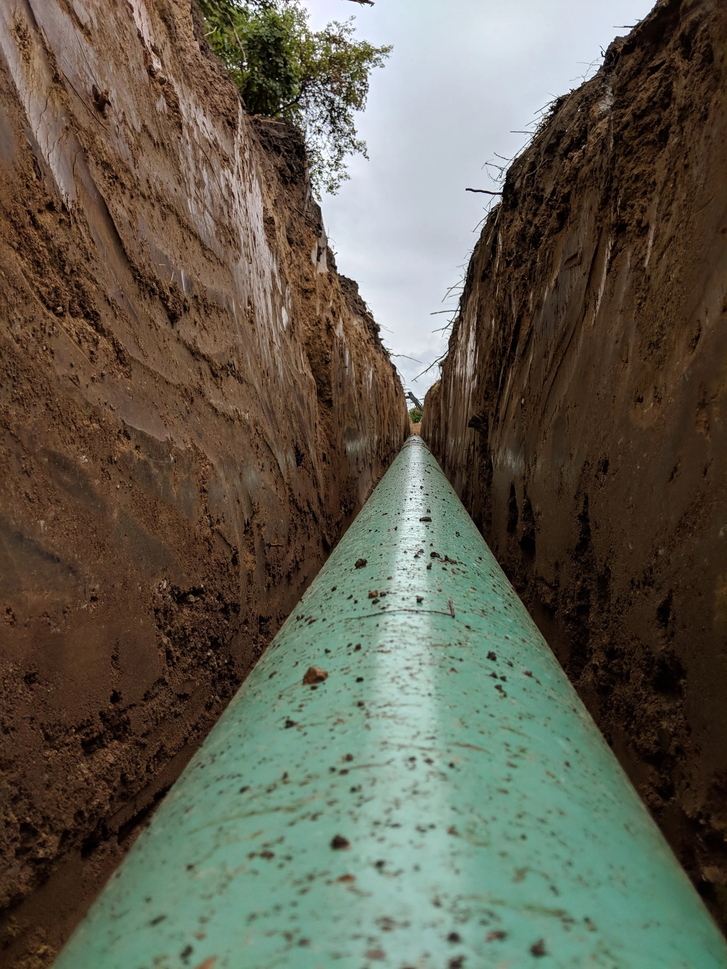 steel pipeline photo sitting in a trench