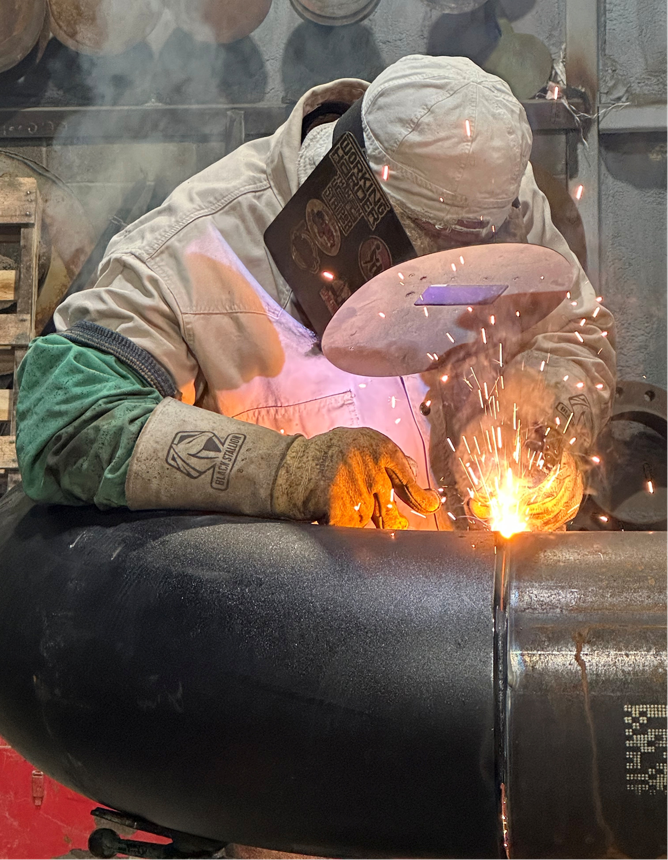 R.L. Coolsaet Construction welder skillfully welds piping per API 1104