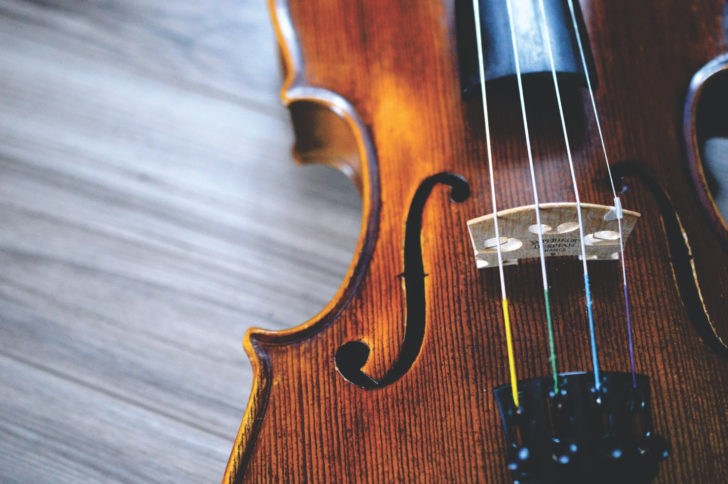 Close-up of a wooden acoustic guitar with visible strings, fretboard, and a part of the body.