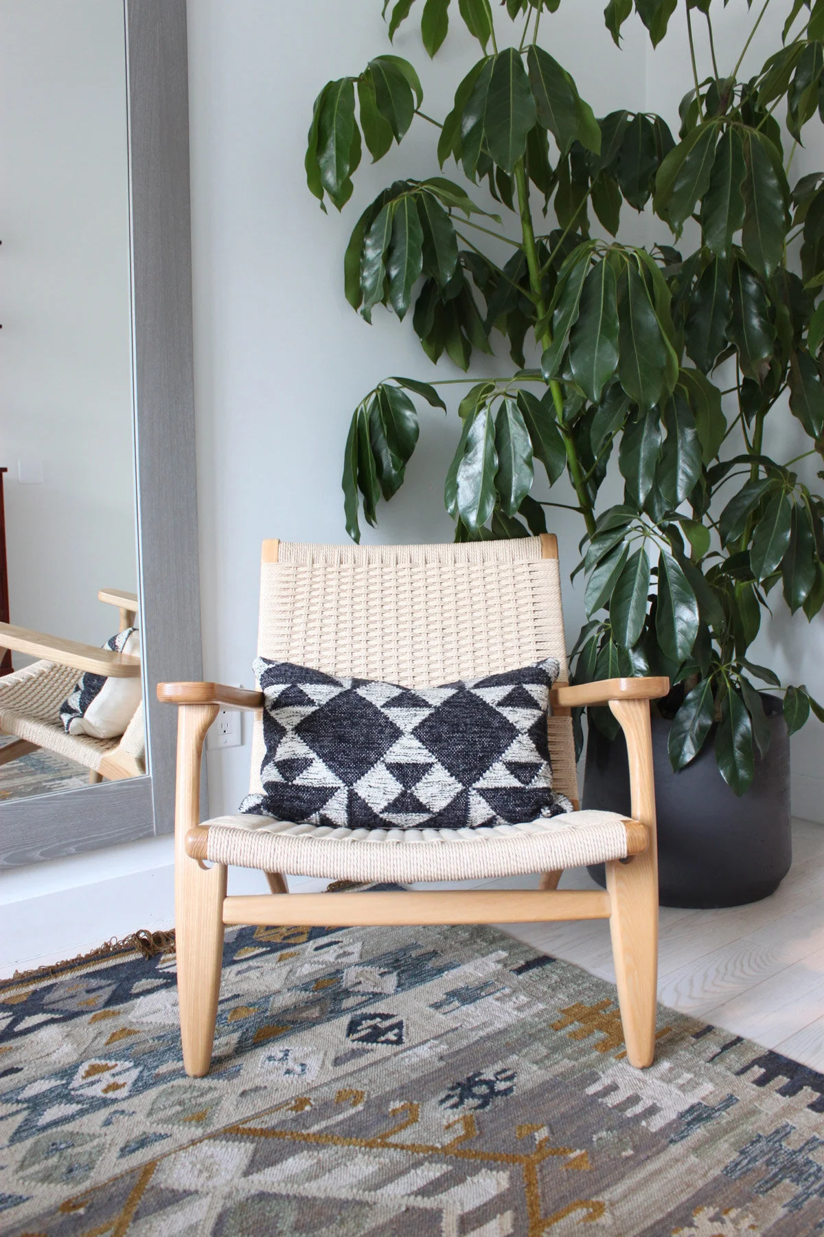 danish-wicker-chair-with-dark-grey-rug.jpg