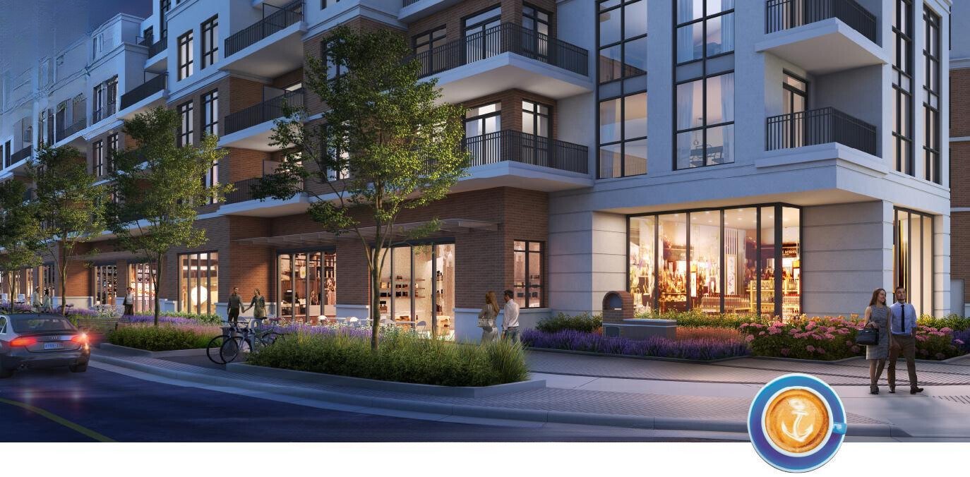 Modern mixed-use apartment building with large windows, balconies, and ground-floor retail shops at dusk; cars and pedestrians in the foreground along a landscaped sidewalk.