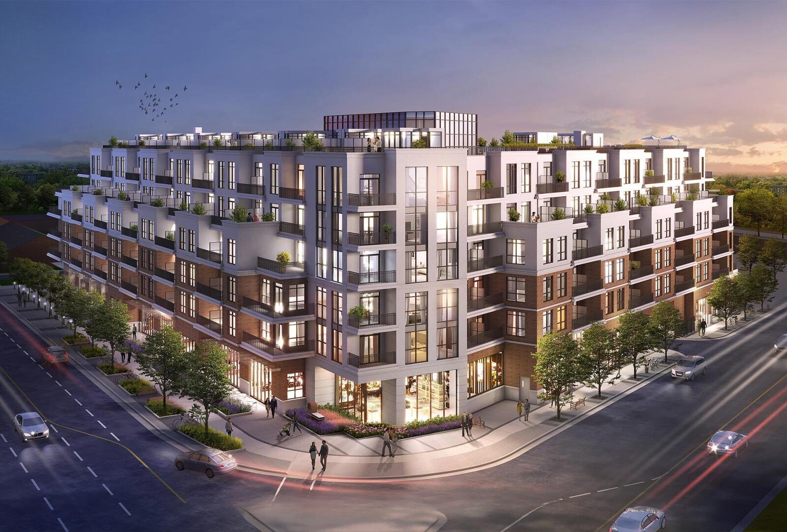 Modern multi-story apartment building with balconies and greenery, located on a city street corner at dusk.
