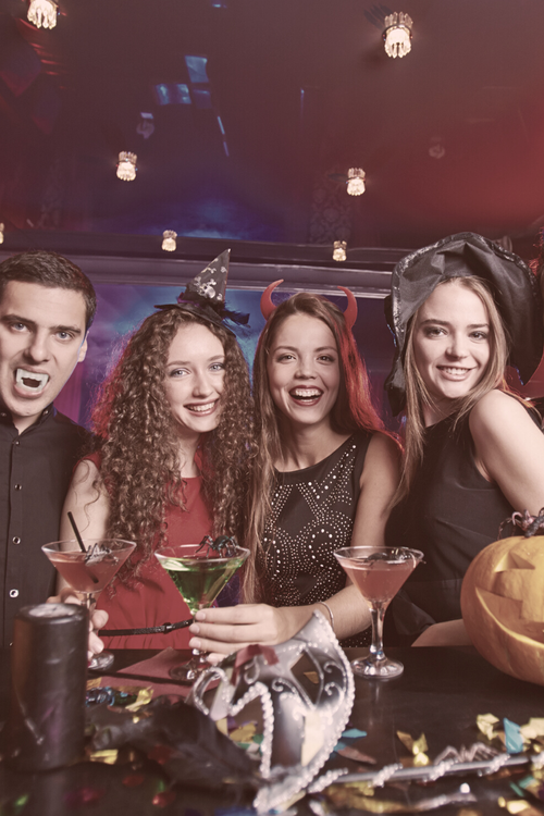 Group of friends enjoy Halloween cocktails