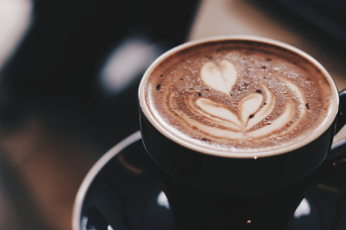 Coffee shop near me a latte with a heart shape in the foam