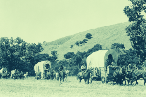 Historic Kansas Holidays pioneers with covered wagon