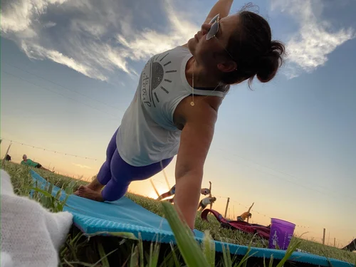 Woman does outdoor yoga at our Lawrence vineyard