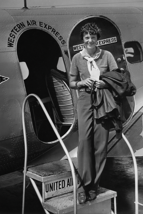 Amelia Earhart in front of a plane