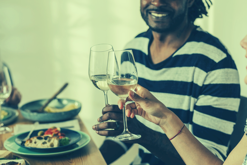 A man and woman toasting with wine glasses