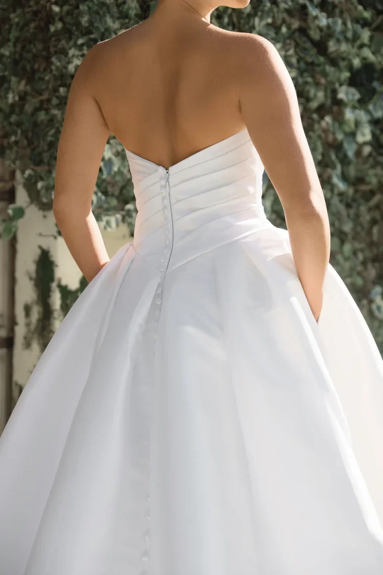 Back view of Camilla strapless white wedding gown with buttoned bodice