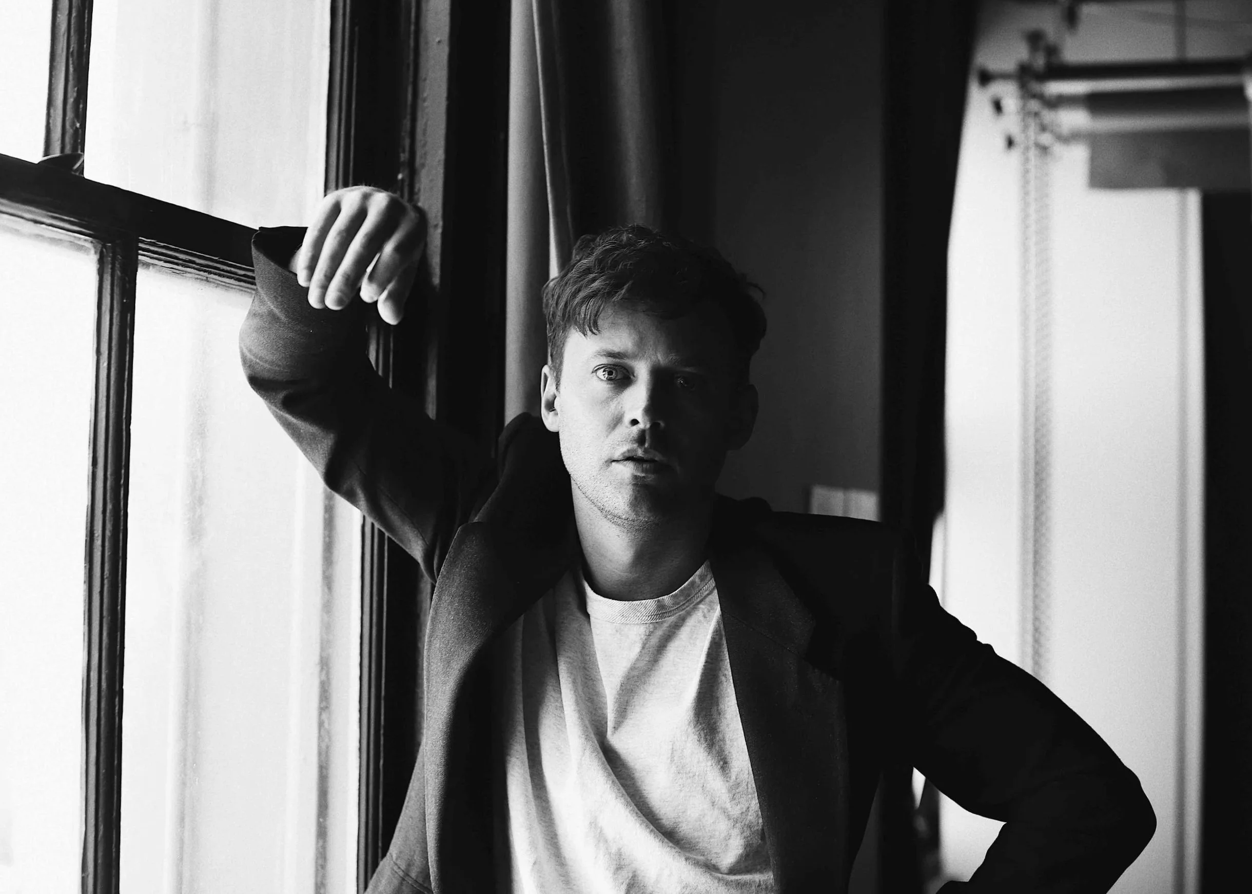 Black and white studio portrait of actor Oliver Ackland photographed by Rebecca Hitch in Sydney