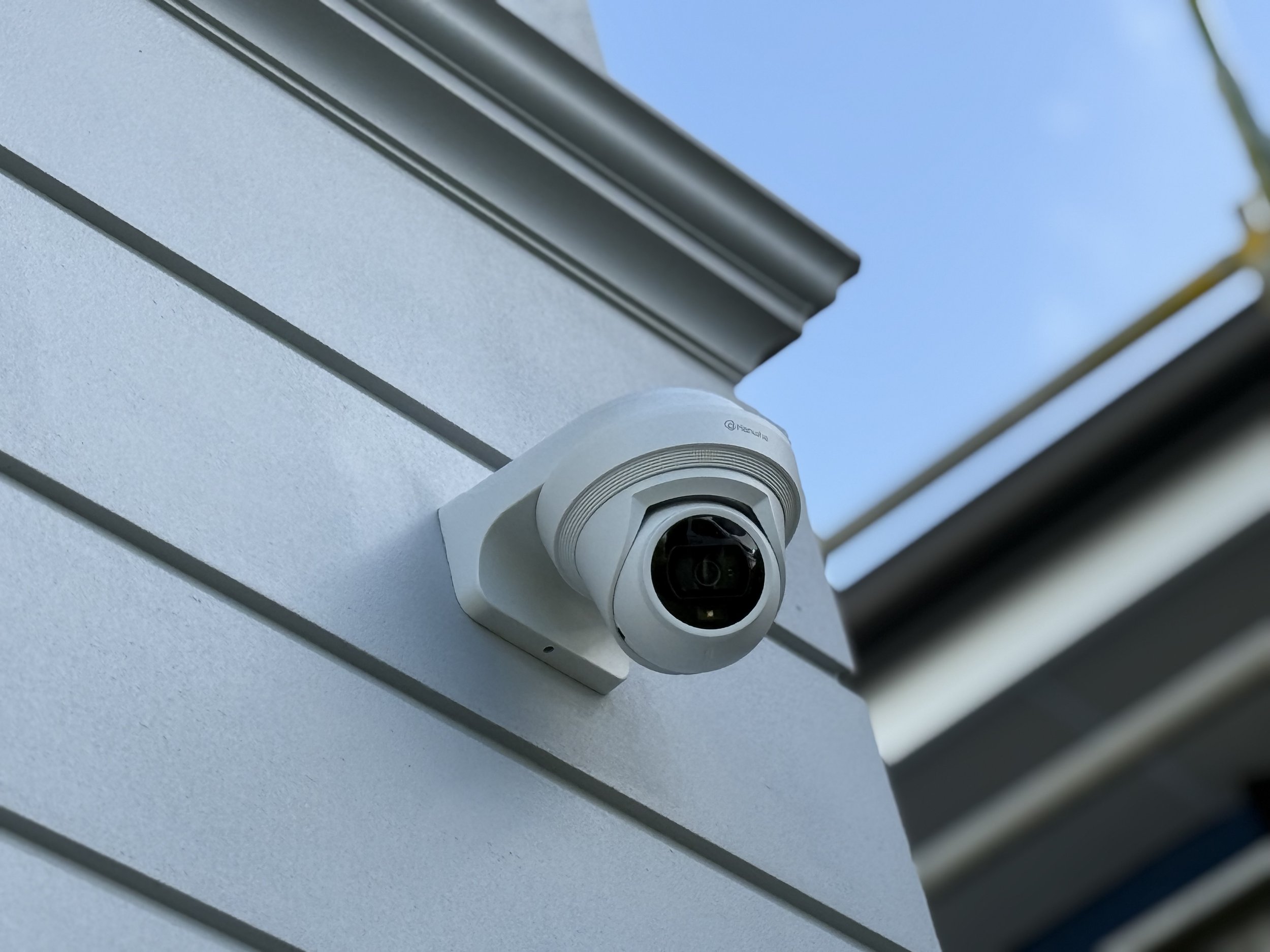 Security camera mounted on an exterior building wall