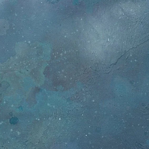 A close up detail photo of “Drifting Melody” artwork.  Close-up image of a textured, dark-colored wall with cracks and small paint splatters.