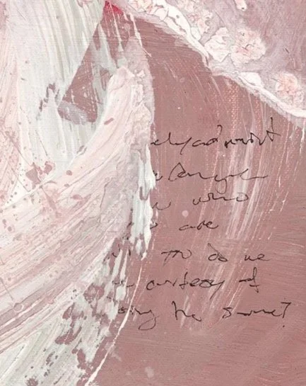 A close up detail photo of “Fading Memories” artwork. Close-up of a pink and white abstract painting with handwritten text.