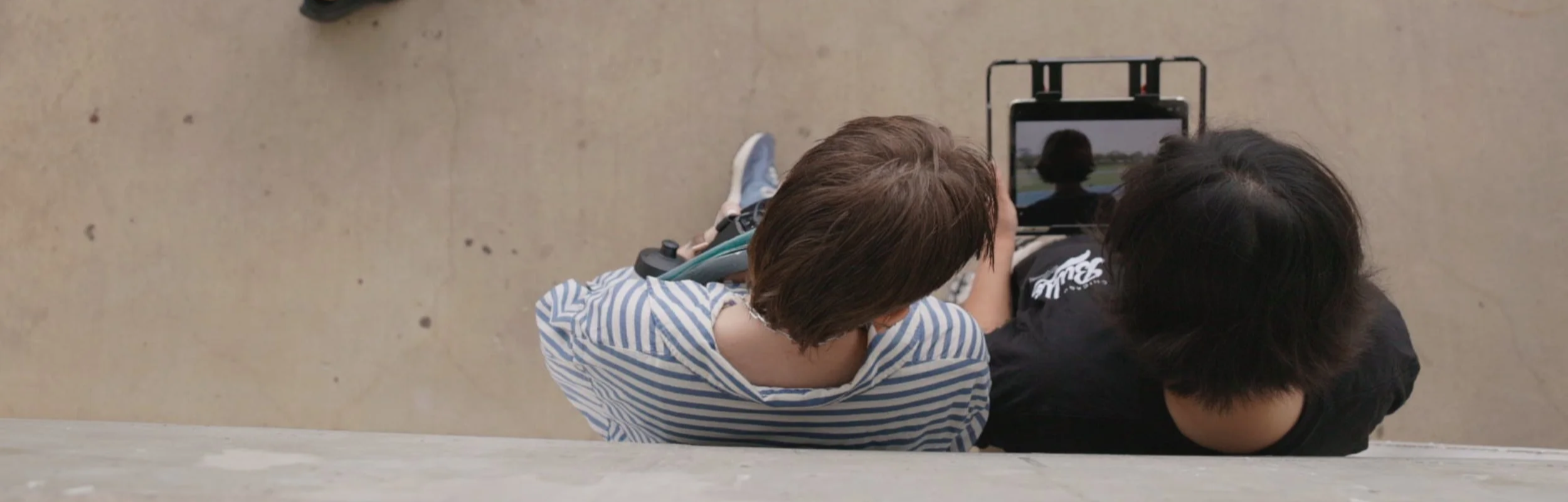 Kate Campbell & Claire Ha, looking at a tablet screen and Co-Directing Everywhere