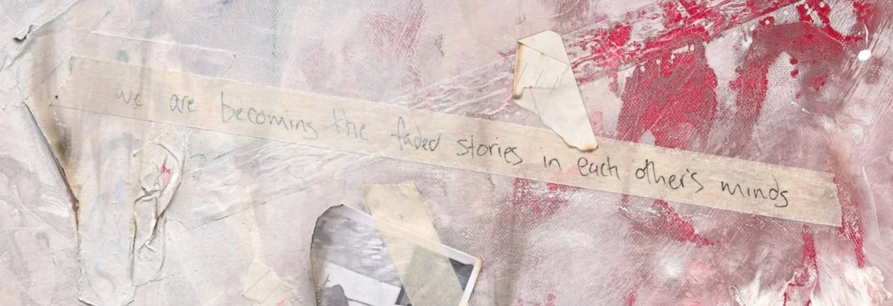 A close up detail photo of “Fading Memories” artwork. Handwritten note on a wall that says, 'we are becoming the faded stories in each other's minds,' with torn and stained paper around it.