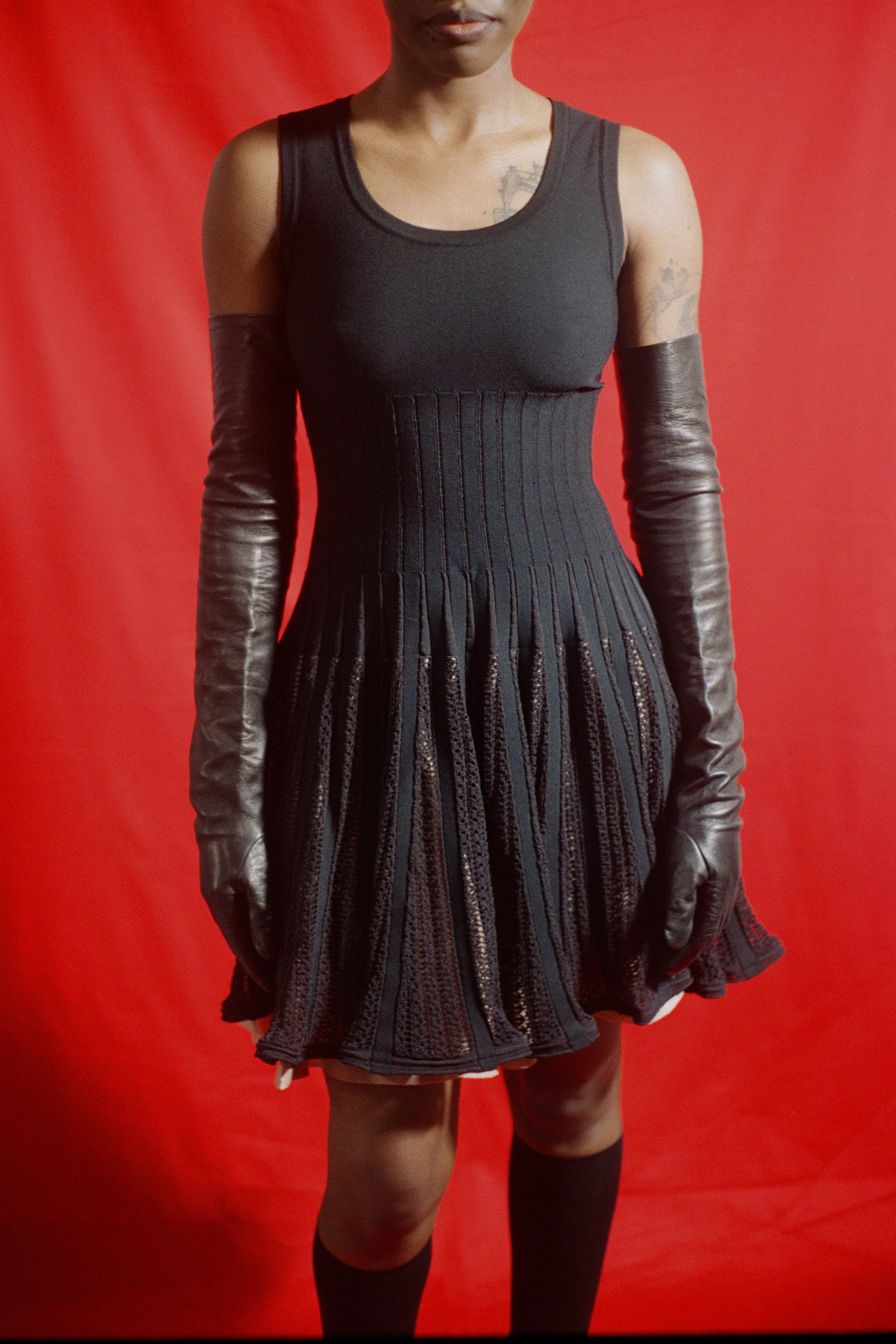 Alaïa designer knit dress with leather gloves