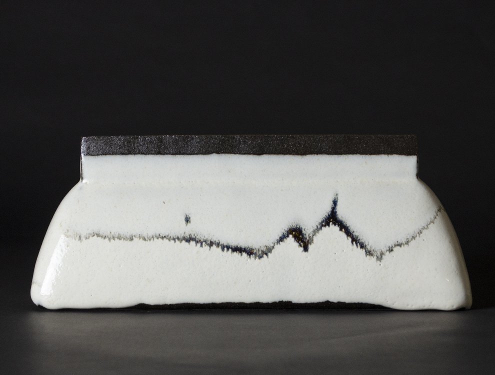 Flat square jar with white glaze and black flow