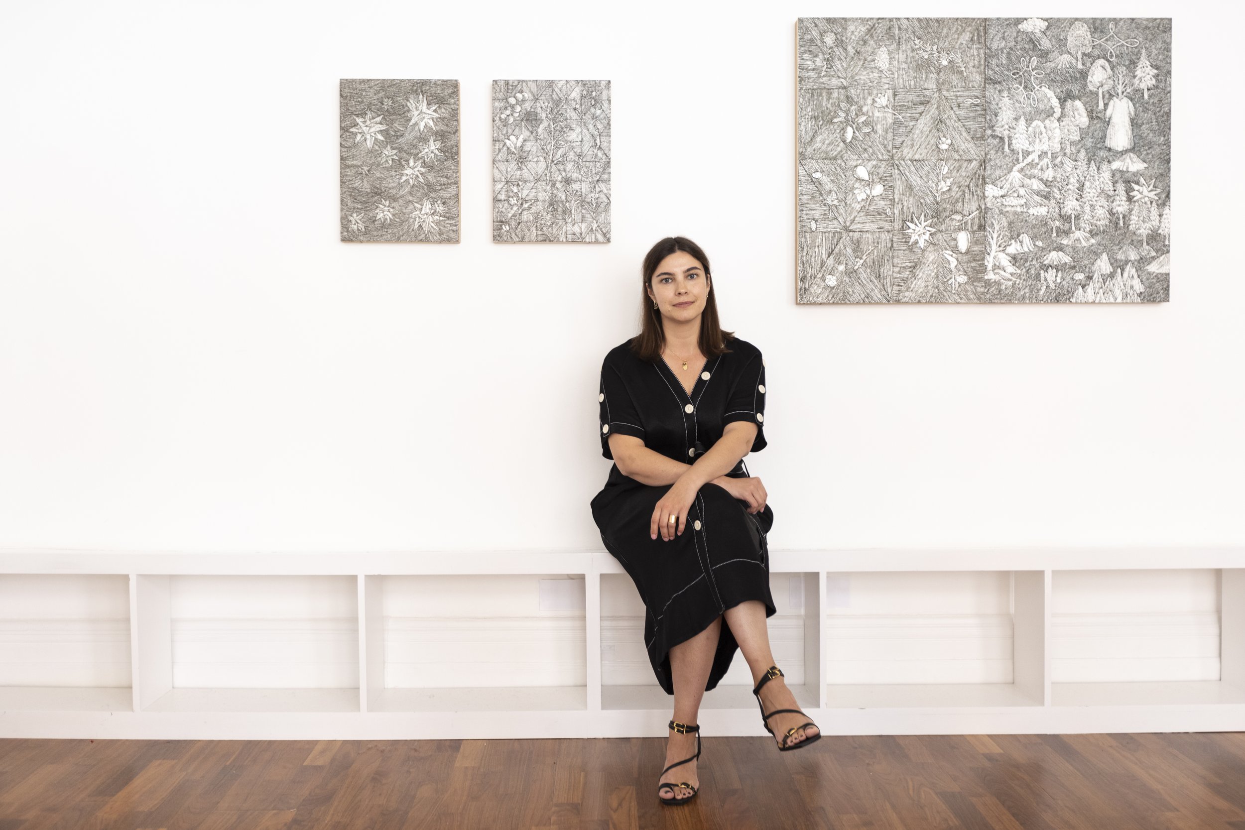 Exhibition curator Julia Tarasyuk posing in front of Nana Funo’s artworks. ©Will Amlot 
