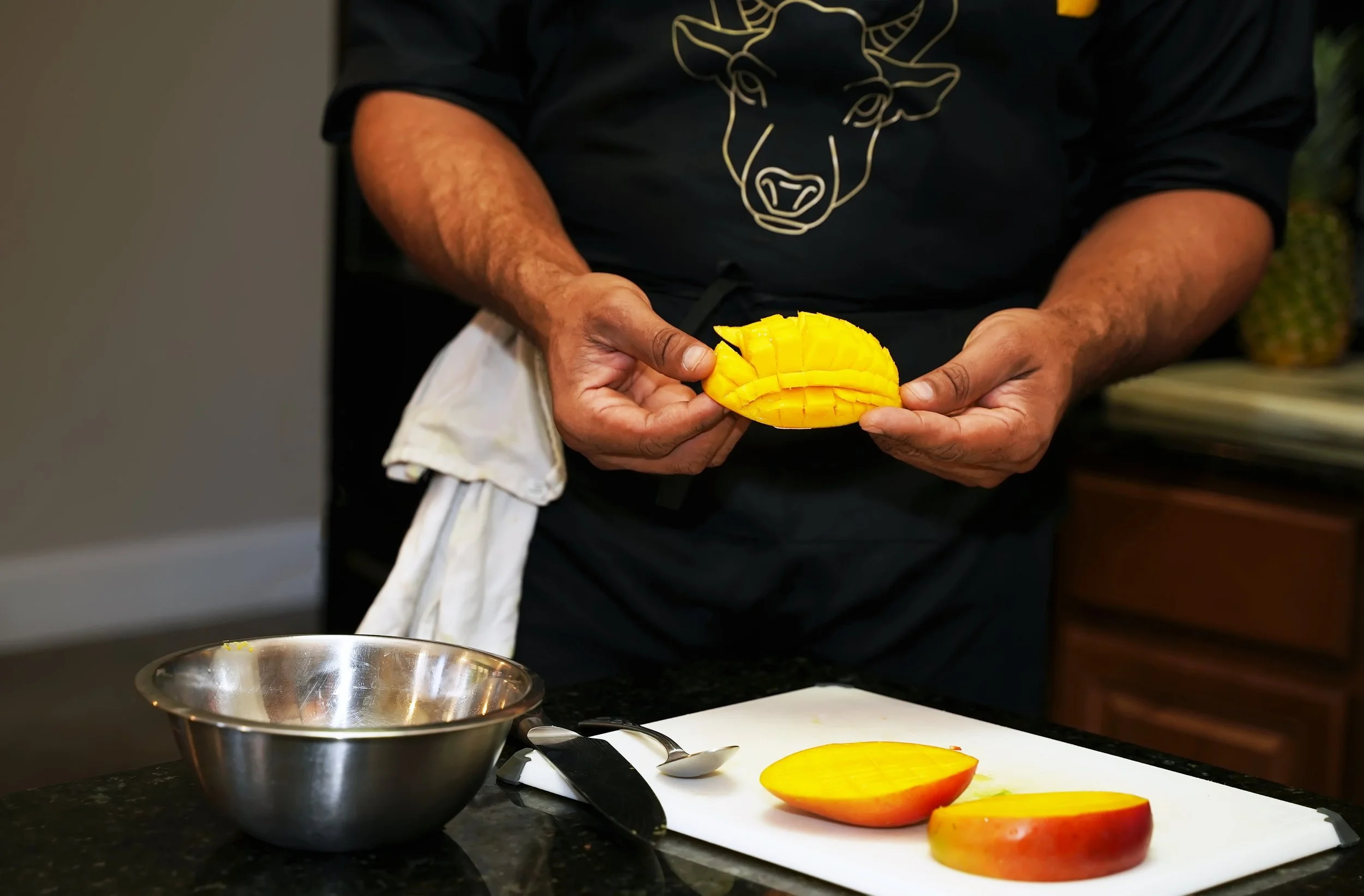 “Big Chef J preparing fresh mango salsa ingredients in the Sivraj Eatery kitchen.”