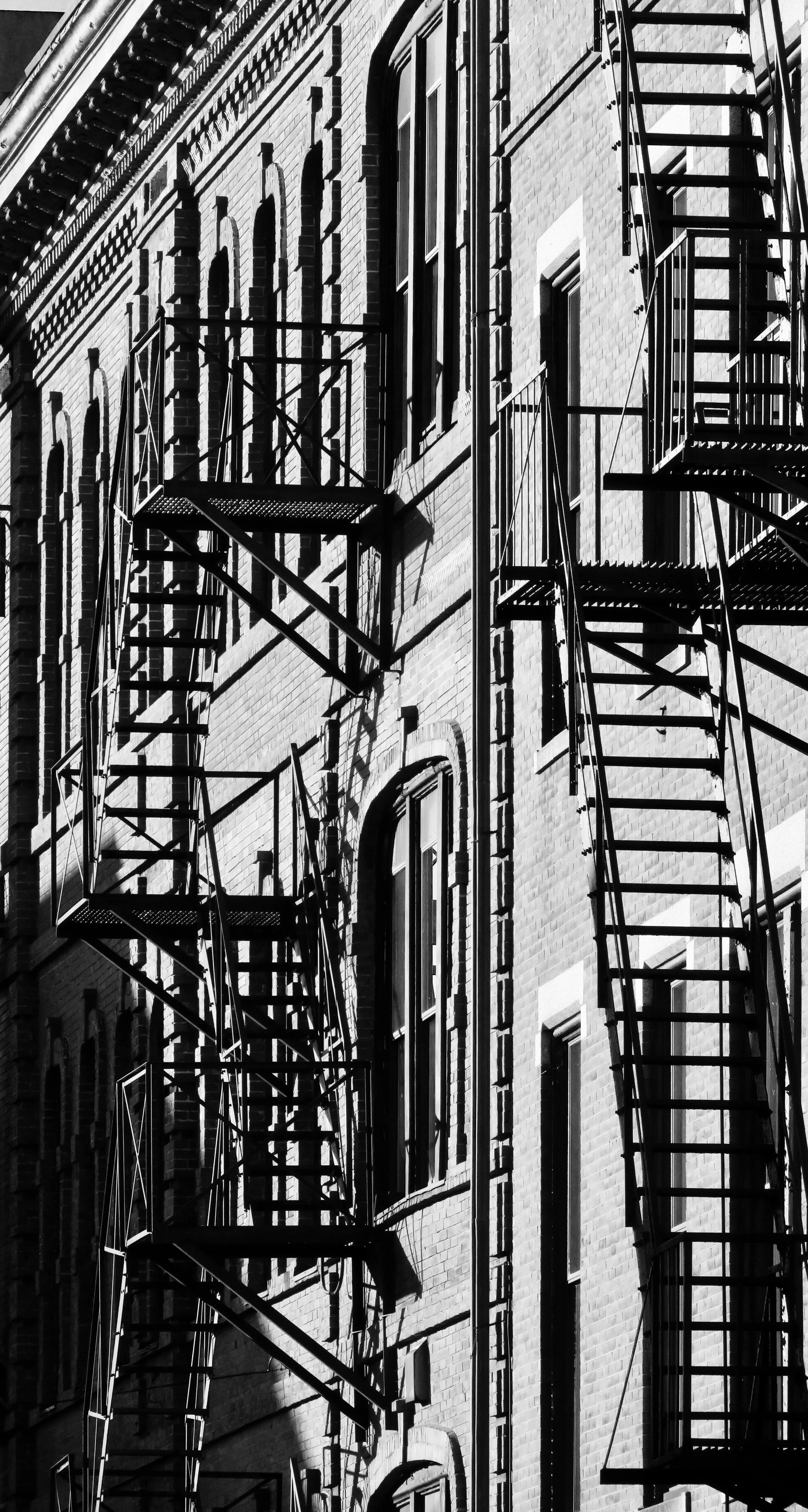  The mostly minimal shadows of the fire escape contribute to the overall effect of the photo.  