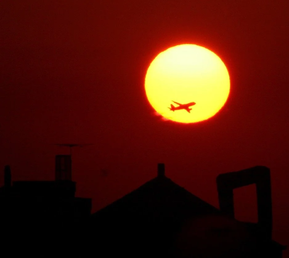  Of all these photos, my favorite is this shot of sunrise, featuring a jet from nearby LaGuardia Airport. 